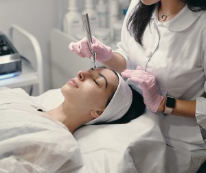 Auburn Alabama aesthetician giving facial treatment with machine